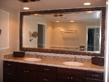 A bathroom with two sinks and a large mirror.
