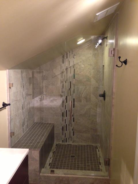 A bathroom with a walk in shower and a bathtub