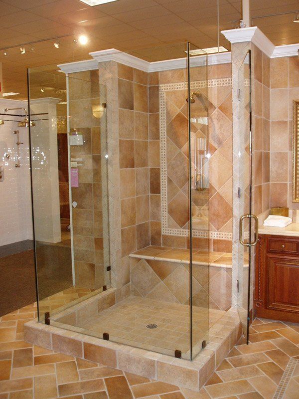 A bathroom with a walk in shower with glass doors