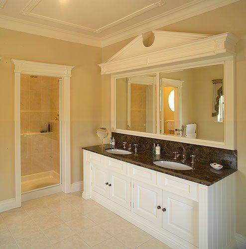 A bathroom with two sinks and a large mirror