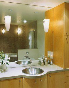 A bathroom with two sinks and a large mirror
