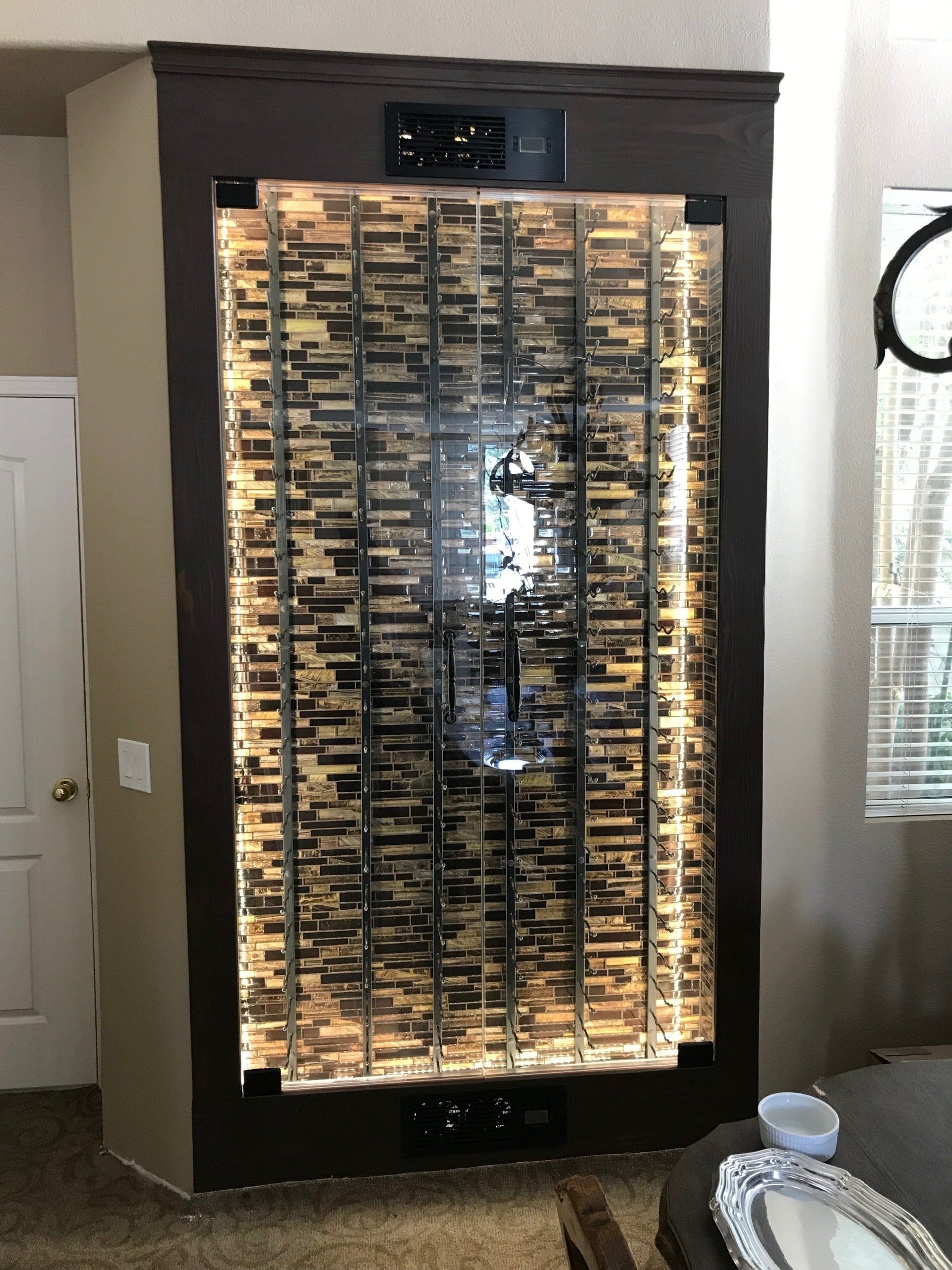 A living room with a large water fountain on the wall.