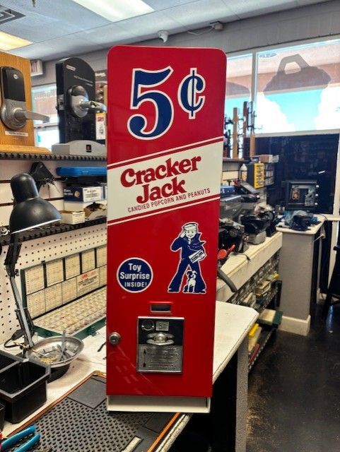 Vintage Cracker Jack vending machine with red and white branding. 