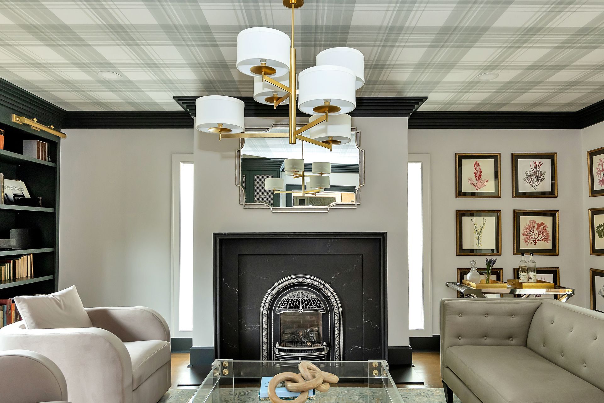 Living room with plaid ceiling, fireplace, furniture, and gold chandelier.