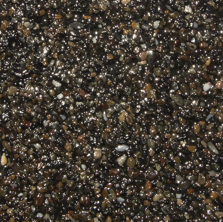 Close-up of wet, dark gravel with shimmering highlights.