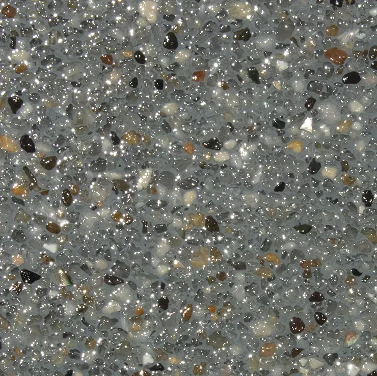 Speckled, shiny, grey surface with small, multicolored stones.