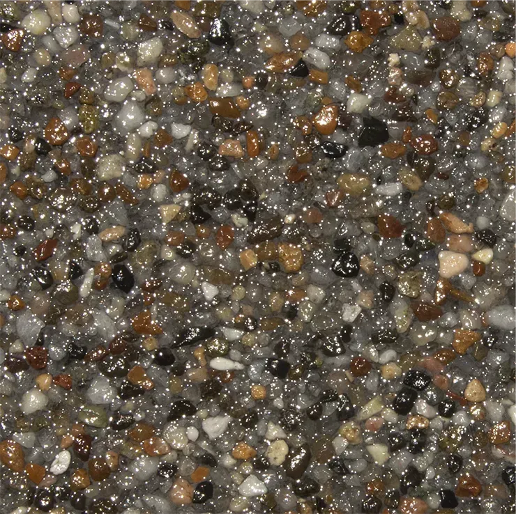 Close-up of a speckled, glossy surface with small pebbles in shades of gray, brown, and tan.