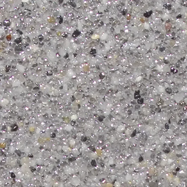 Close-up of a speckled, gray stone surface with reflective, shiny qualities.