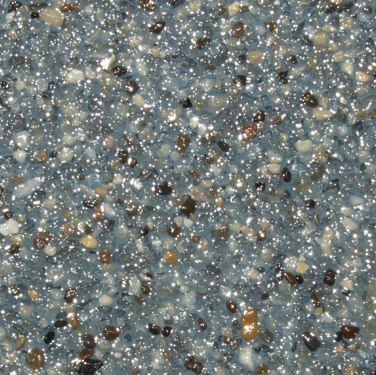 Close-up of a speckled, shiny surface with a mix of small, rounded stones in shades of gray, brown, and tan.