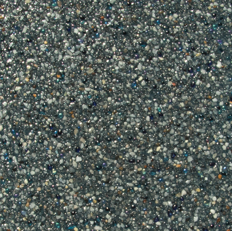 Close-up of a speckled, dark gray pool surface with embedded, sparkling crystals.