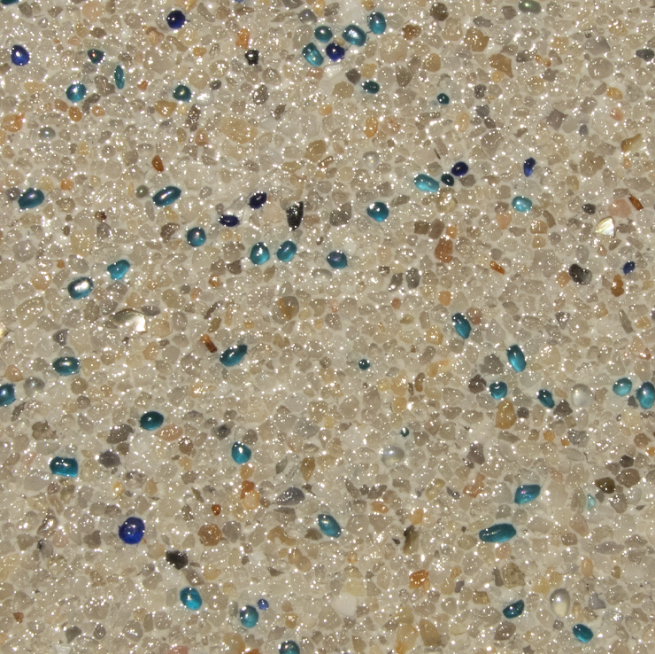 Close-up of a speckled, textured surface with tiny beige, brown, and blue stones.