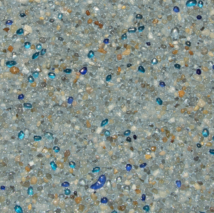 Close-up of a light blue speckled surface with small blue and brown glass-like beads.