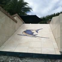Tiled ramp with a blue and gold marlin mosaic.