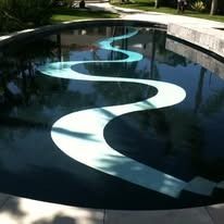 Swimming pool with a turquoise and white curvy design.