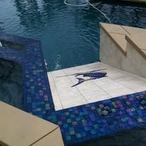 Blue tiled swimming pool with white tile inlay of a marlin.