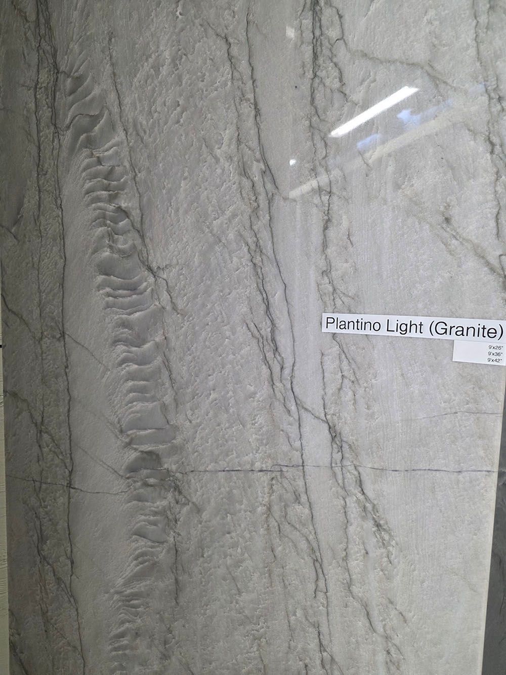 A slab of light grey granite with thin, darker grey veining.
