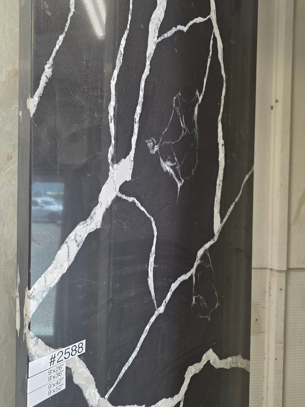 A polished black stone slab with prominent, branching white veining.