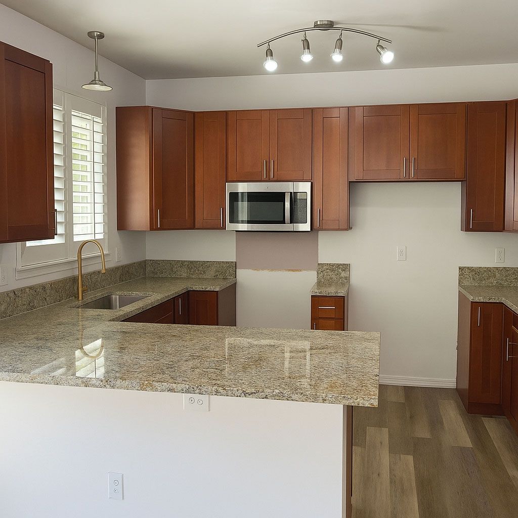 A kitchen with wooden cabinets and granite counter tops