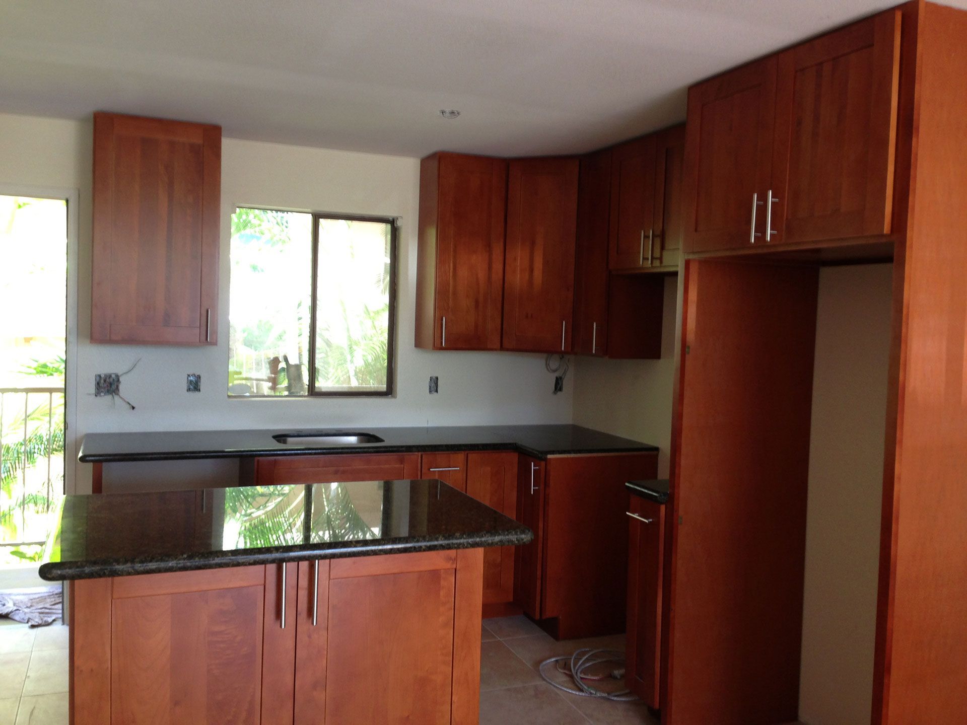 A kitchen with wooden cabinets and granite counter tops