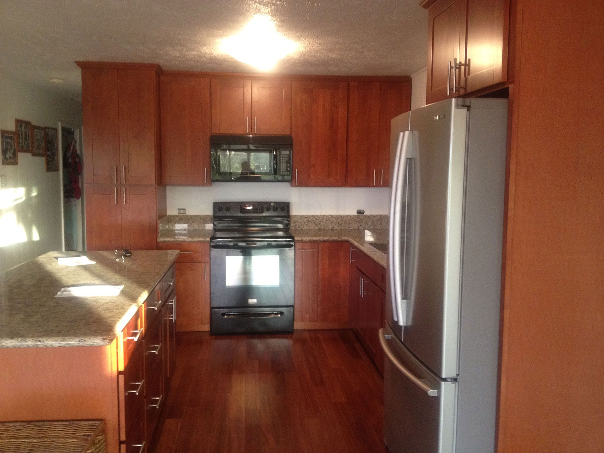 A kitchen with stainless steel appliances and wooden cabinets