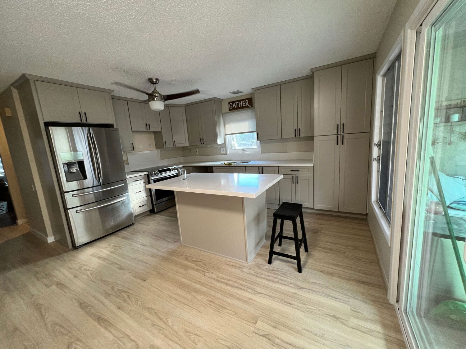 A kitchen with stainless steel appliances and a large island.