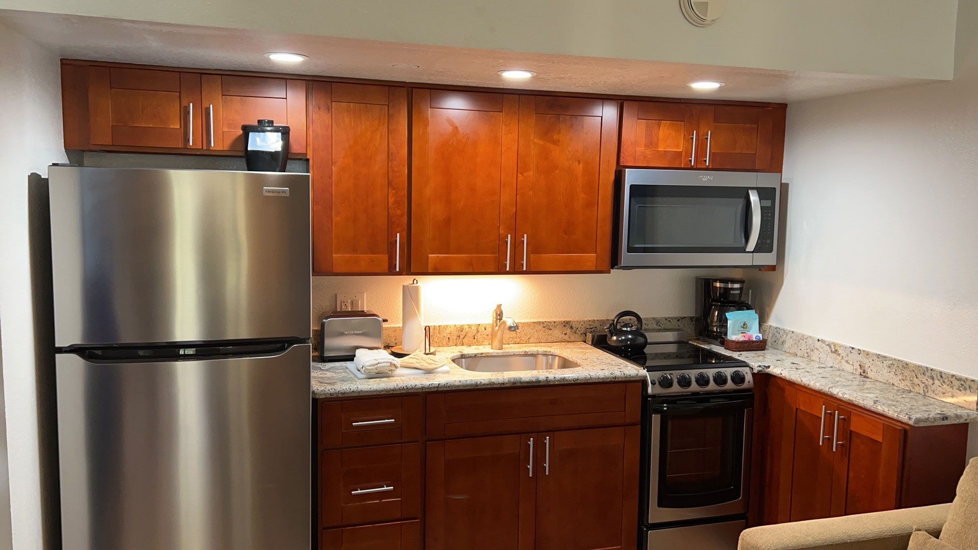 A kitchen with stainless steel appliances and wooden cabinets