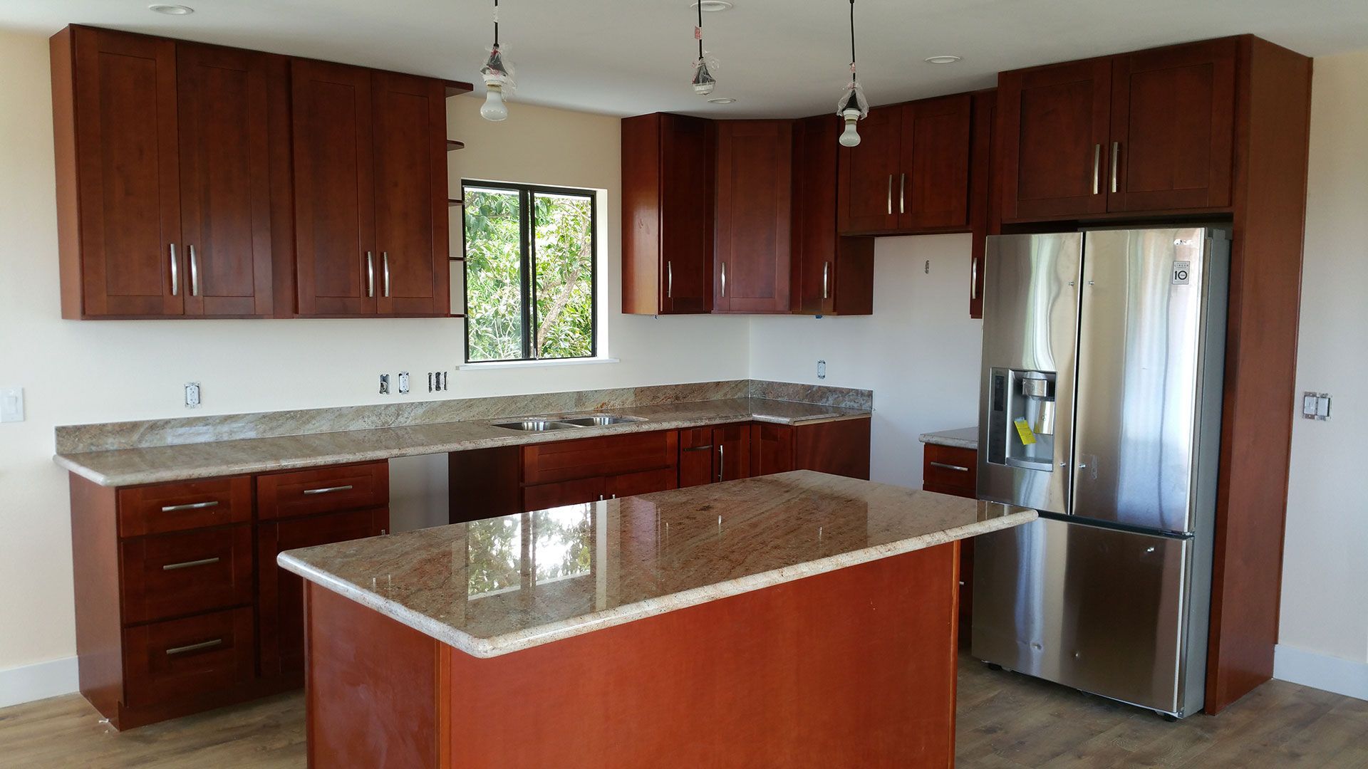 A kitchen with stainless steel appliances and wooden cabinets