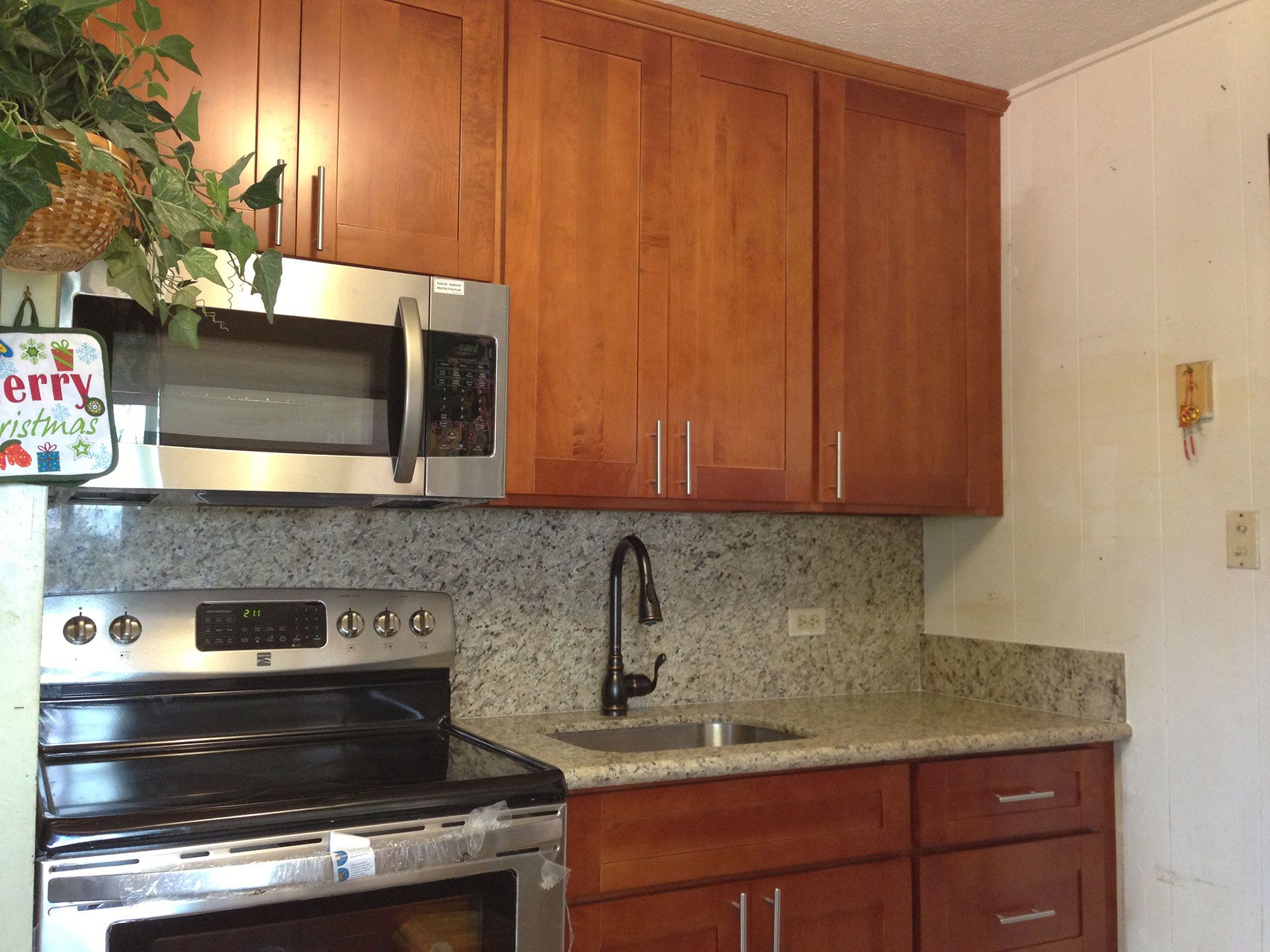 A kitchen with stainless steel appliances and wooden cabinets
