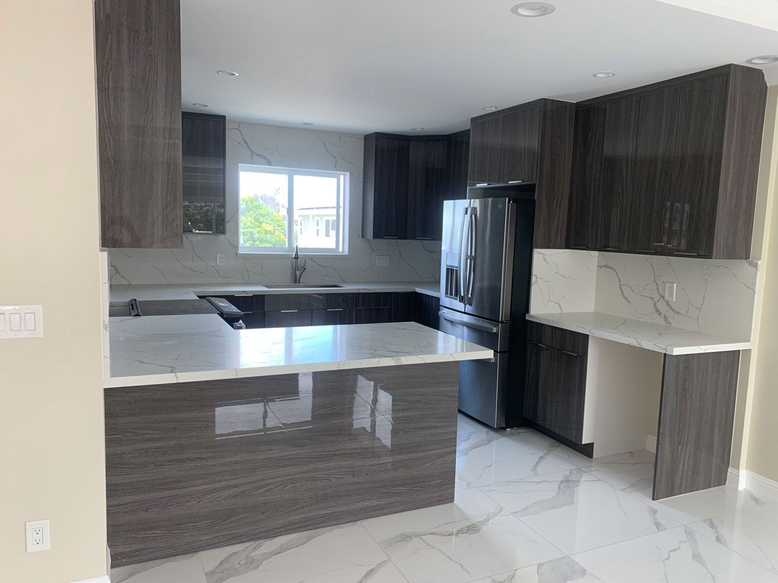 A kitchen with stainless steel appliances and marble counter tops