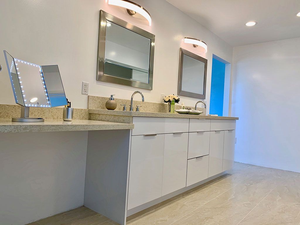 A bathroom with two sinks and two mirrors.