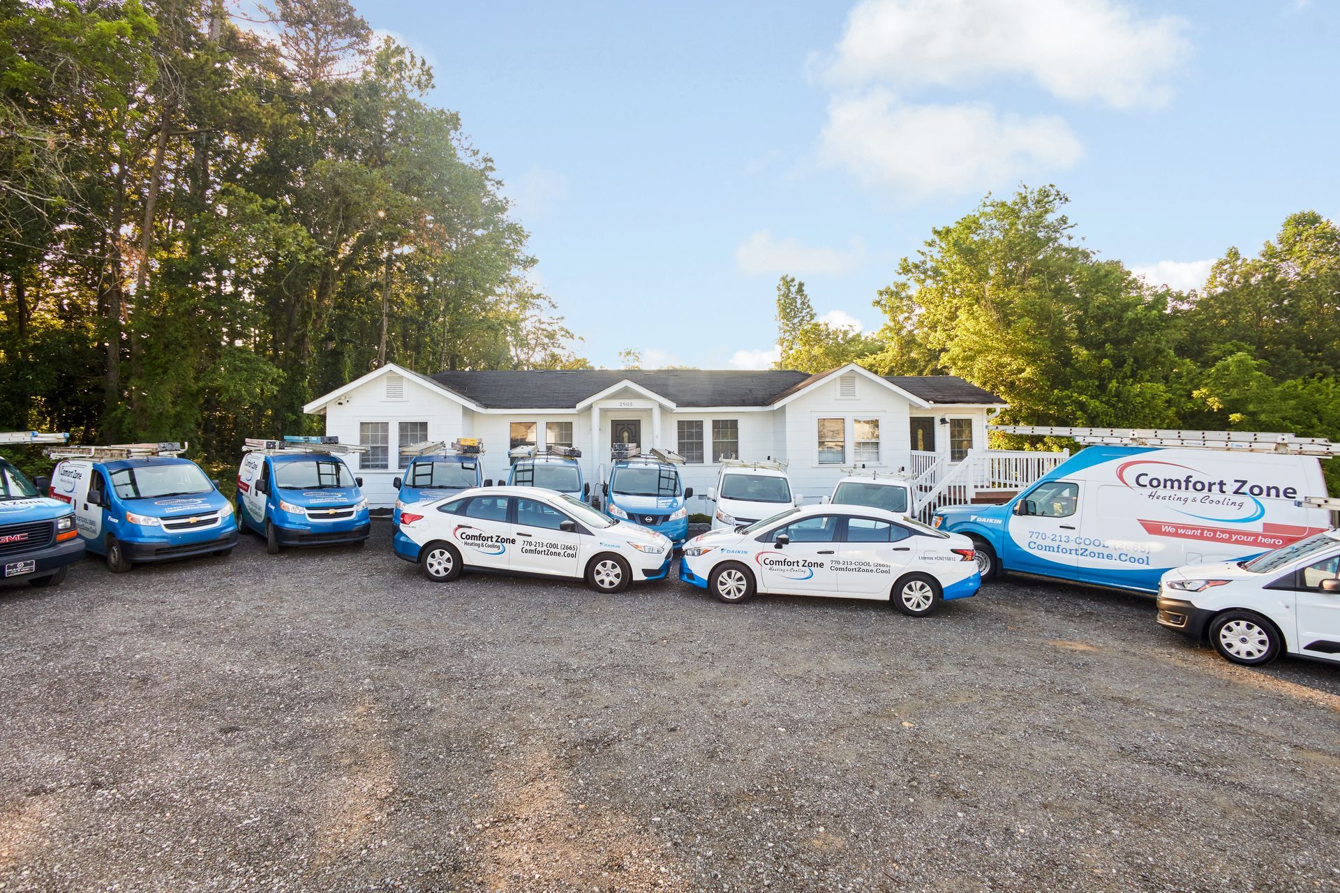 Comfort Zone HVAC company building with fleet of service vehicles parked outside.