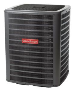 A Goodman brand dark grey outdoor central air conditioning unit against a white background.