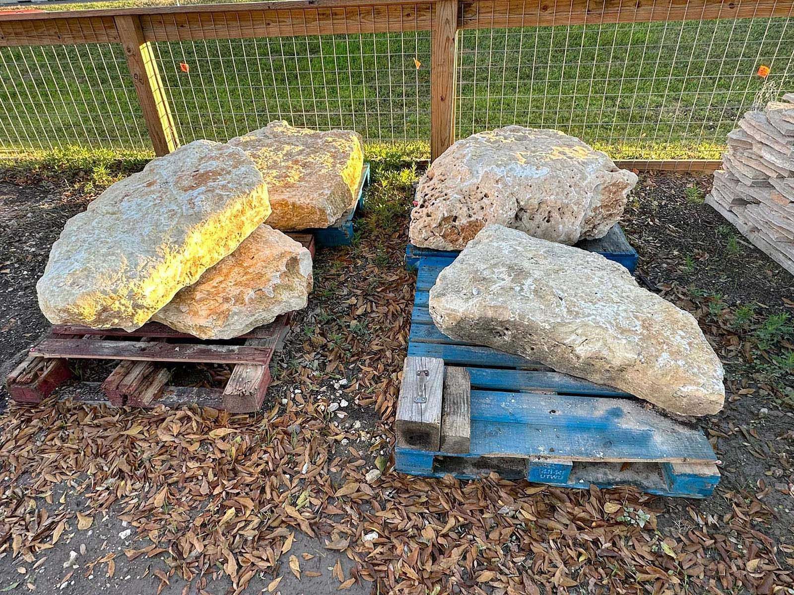 Boulders sitting on top of wooden pallets