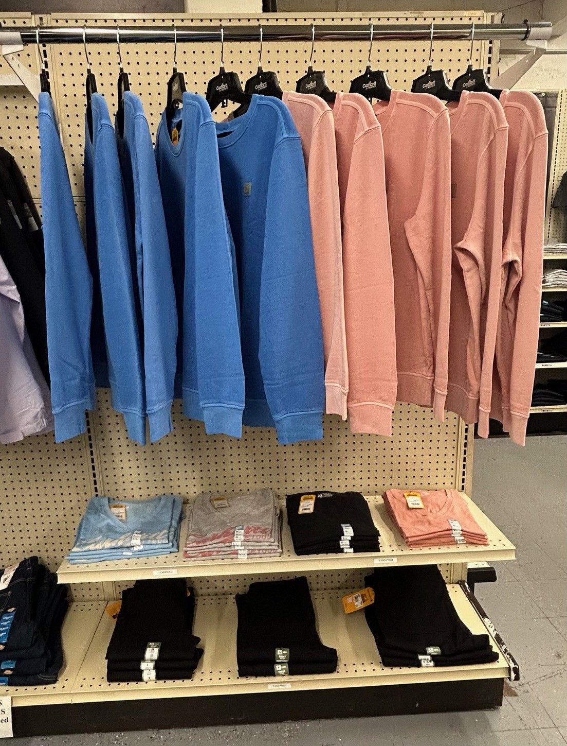 A row of clothes hanging on a rack in a store