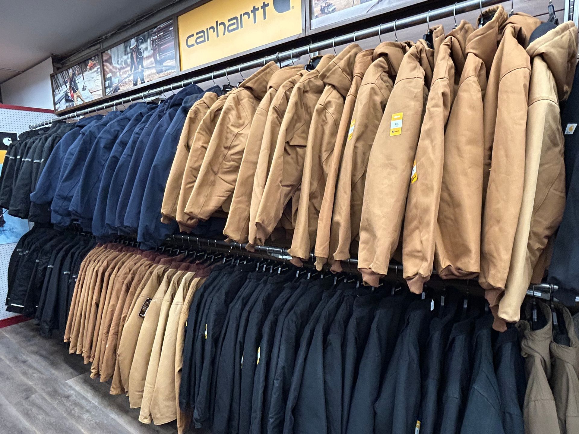 A row of jackets hanging on a rack in a store.