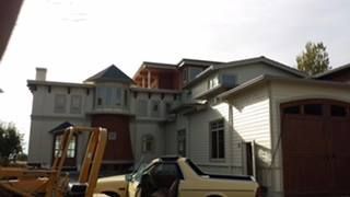 House under construction with a ladder, a pickup truck, and a partially finished garage