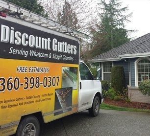 Discount Gutters service van parked by a house, with large yellow and black company signage.