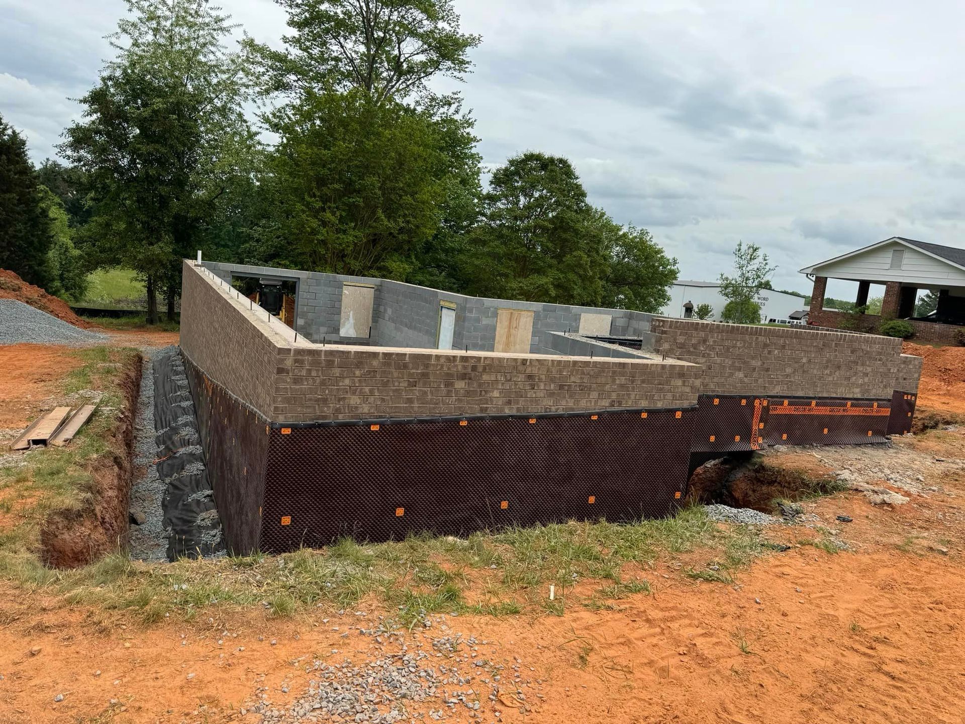 A foundation for a house is being built in a dirt field.
