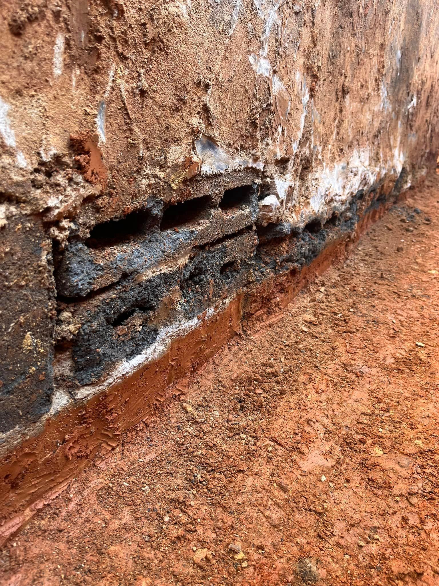 A close up of a brick wall with a hole in it.