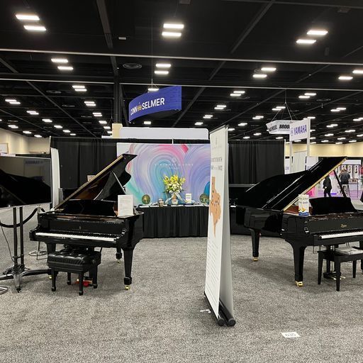 Two grand pianos are sitting in a large room.