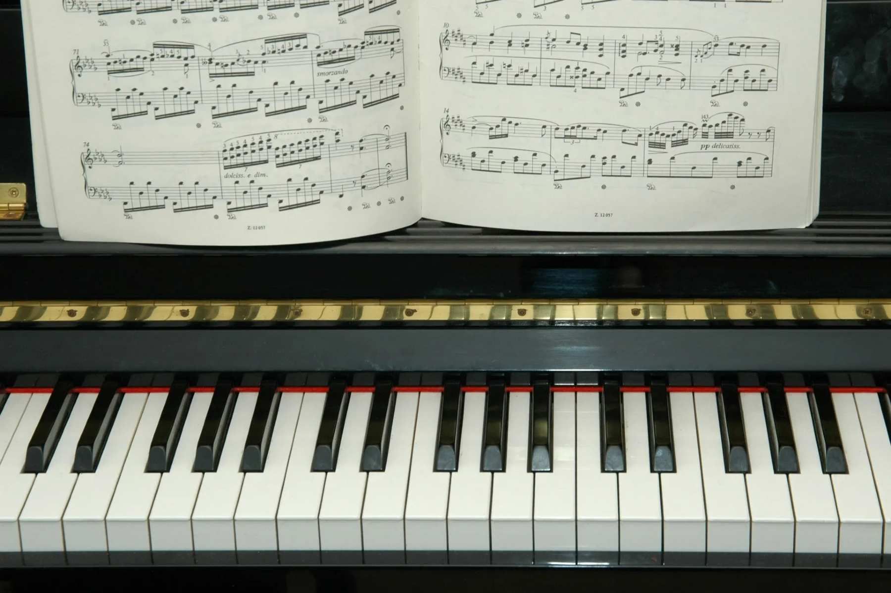 A piano with a sheet of music on top of it