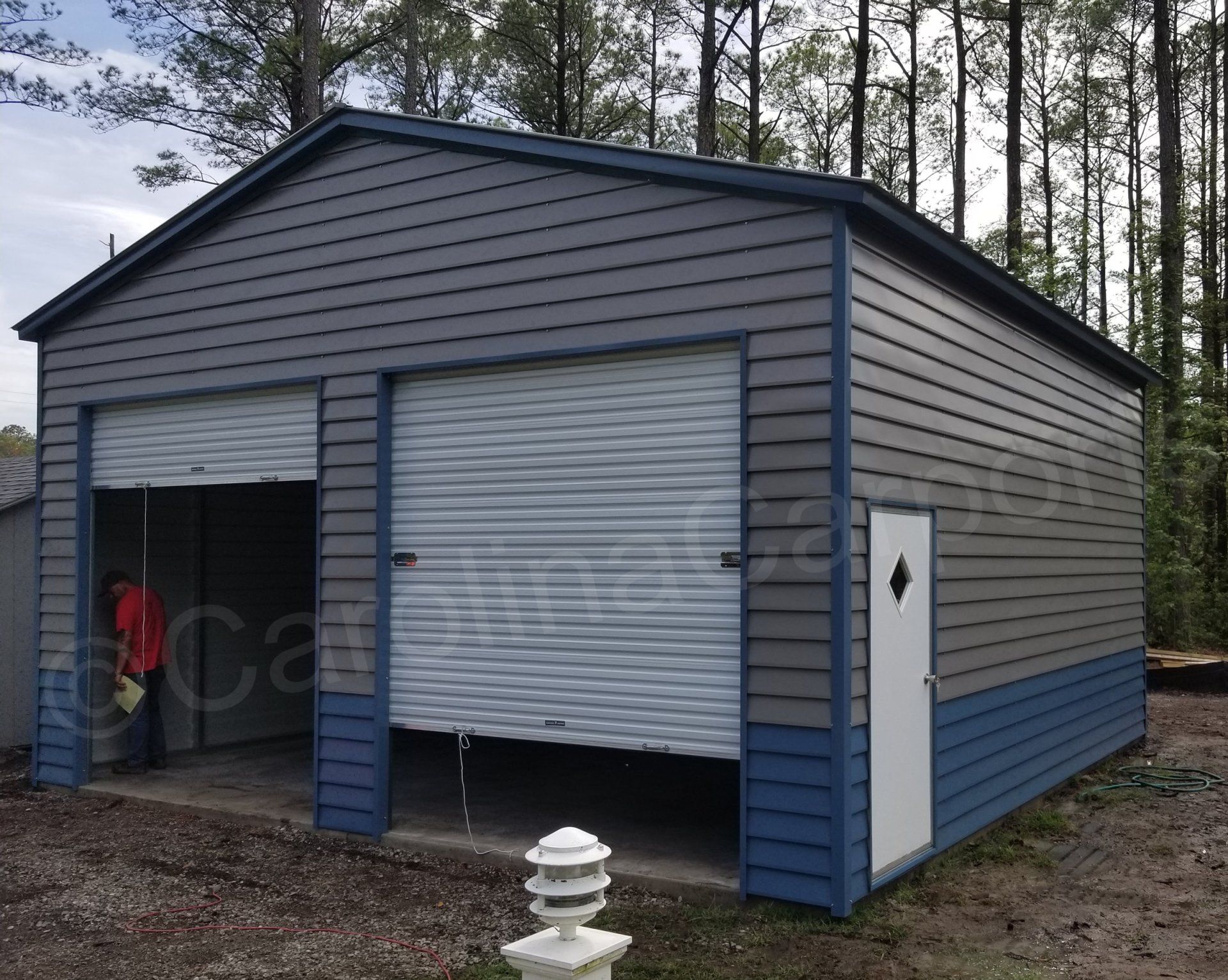 A gray and blue garage with a white door