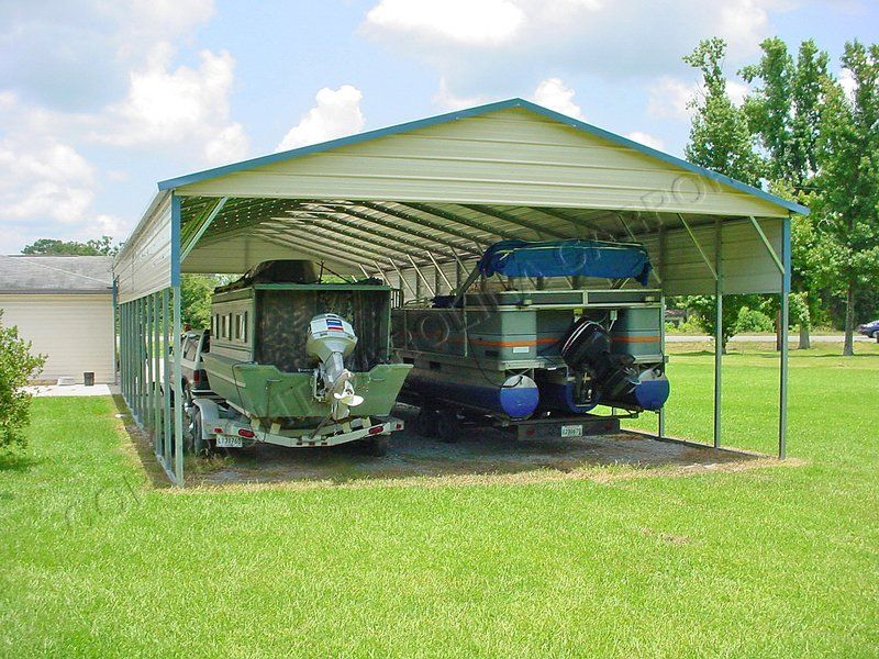 A boat is parked under a metal carport.