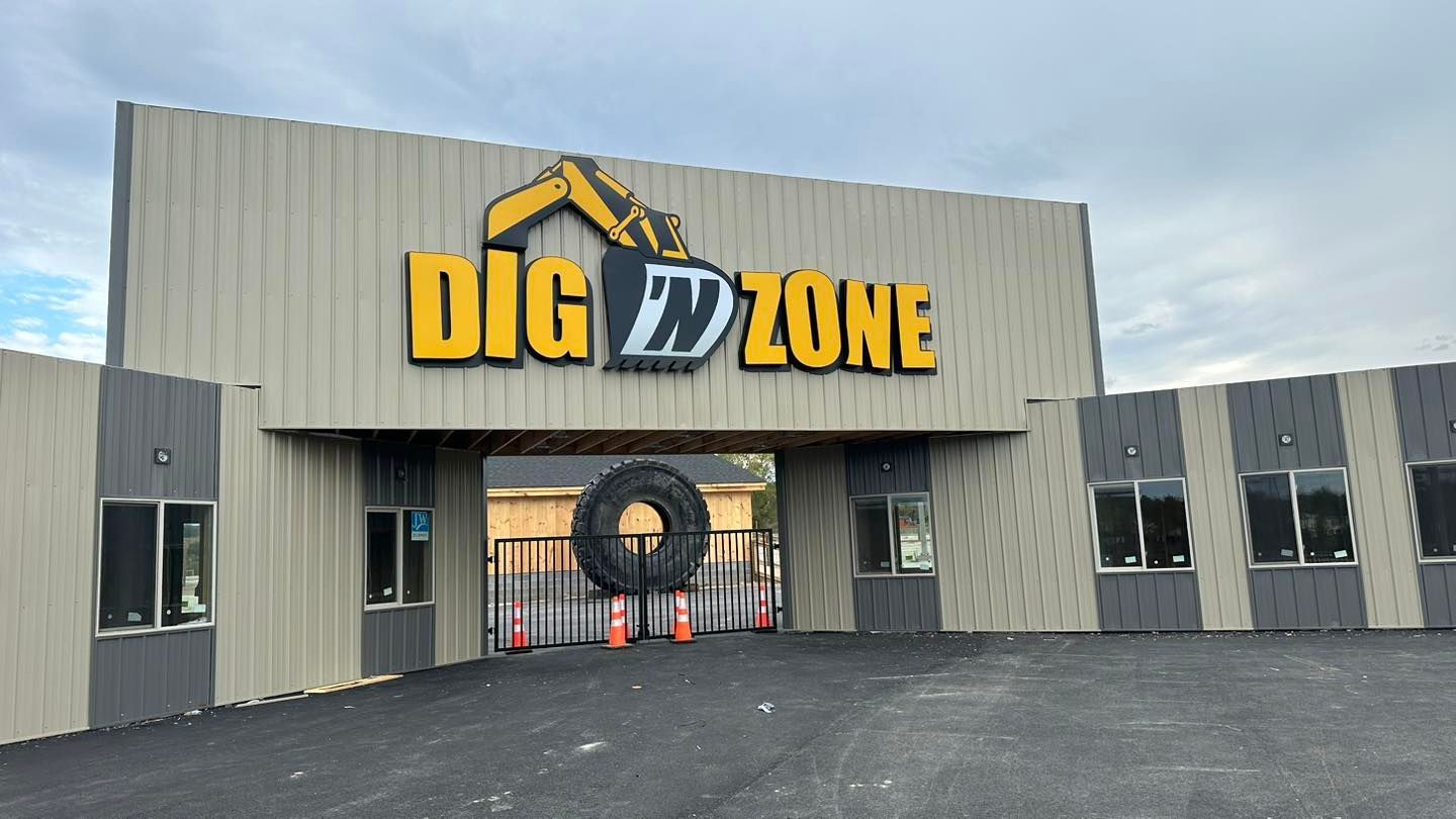 A large building with a sign that says dig zone on it.
