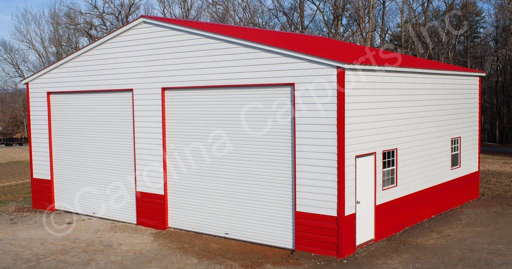 A white garage with red trim and a red roof