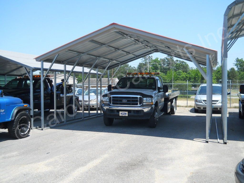 A ford truck is parked under a carport