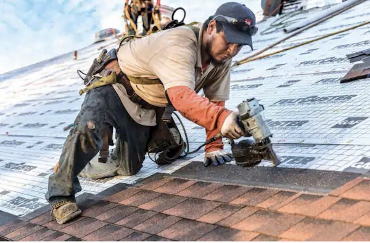 A man is working on the roof of a building.