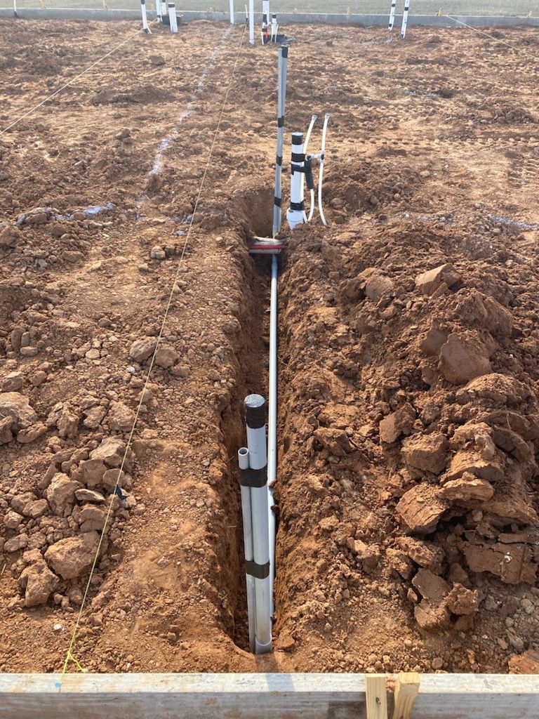 A pipe is being installed in a hole in the ground