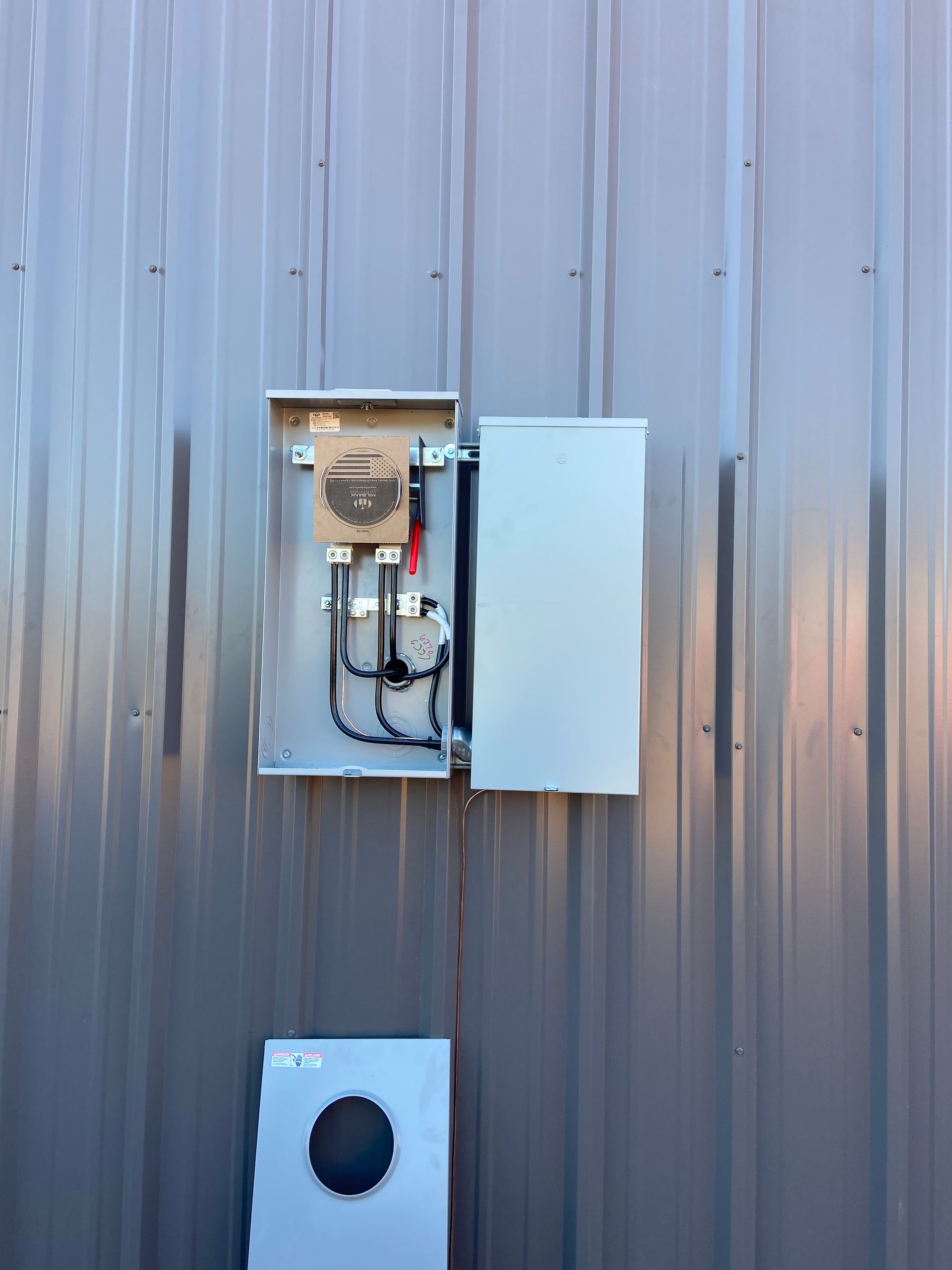 A electrical box is installed on the side of a building