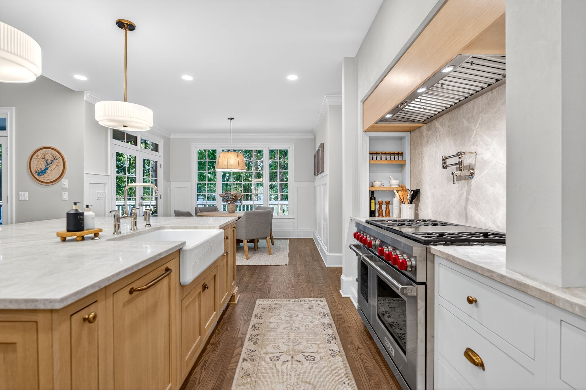 Spacious kitchen with a large island, stainless steel appliances, and a dining area visible in the background.
